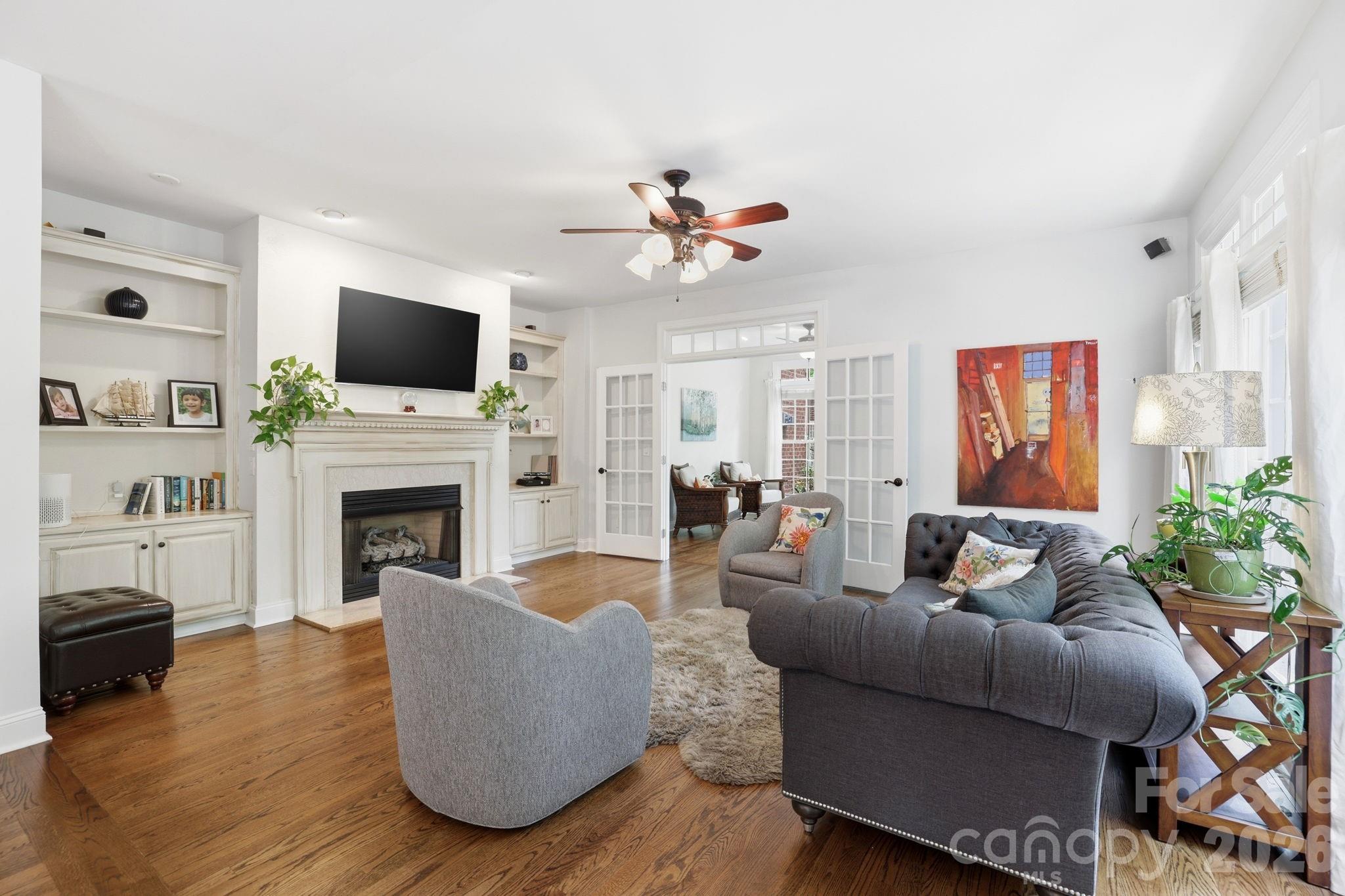 239 Sardis Pointe Road Matthews, NC 28105 - Photo 17 of 47 a living room with furniture a flat screen tv and a fireplace