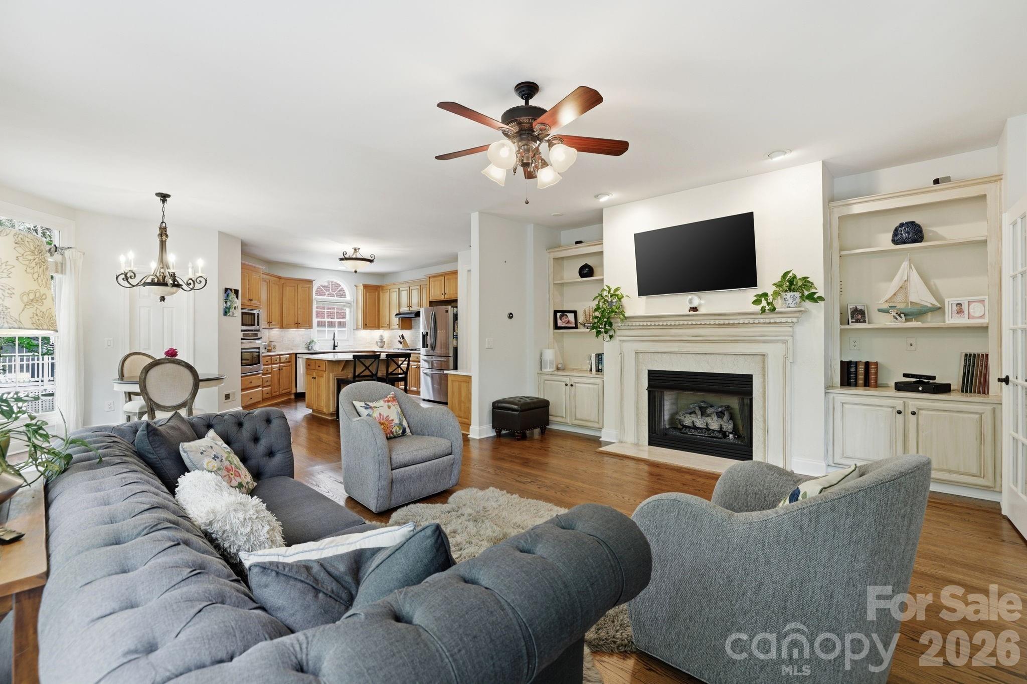 239 Sardis Pointe Road Matthews, NC 28105 - Photo 19 of 47 a living room with furniture a flat screen tv and a fireplace