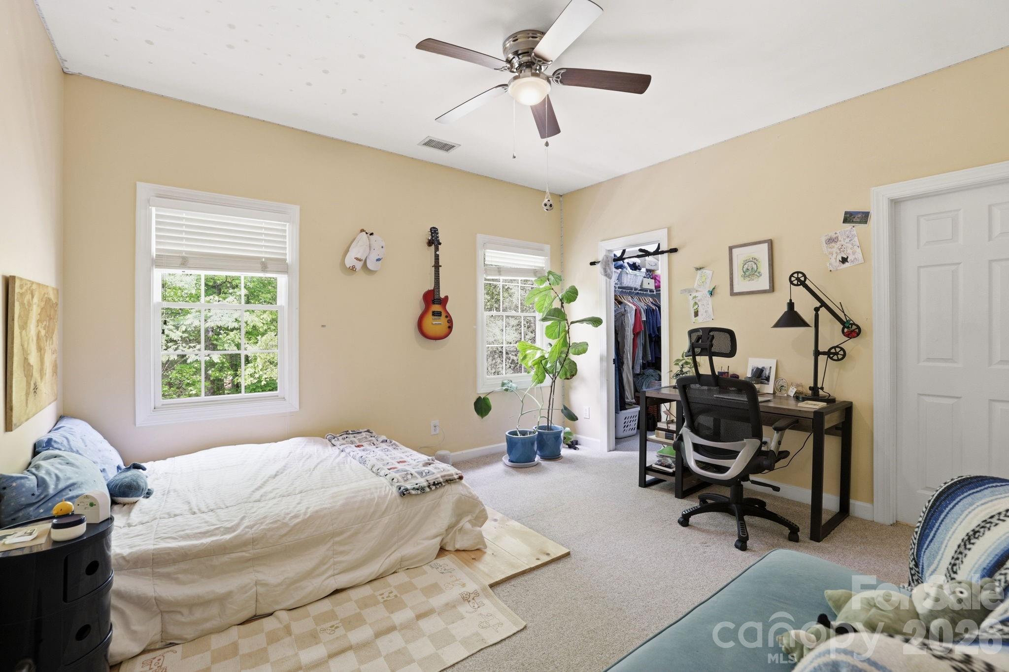 239 Sardis Pointe Road Matthews, NC 28105 - Photo 26 of 47 a bedroom with bed and a chandelier