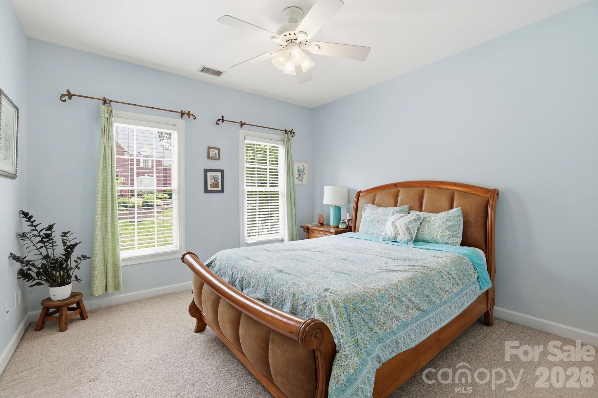 239 Sardis Pointe Road Matthews, NC 28105 - Photo 31 of 47 a bedroom with a bed and a chandelier