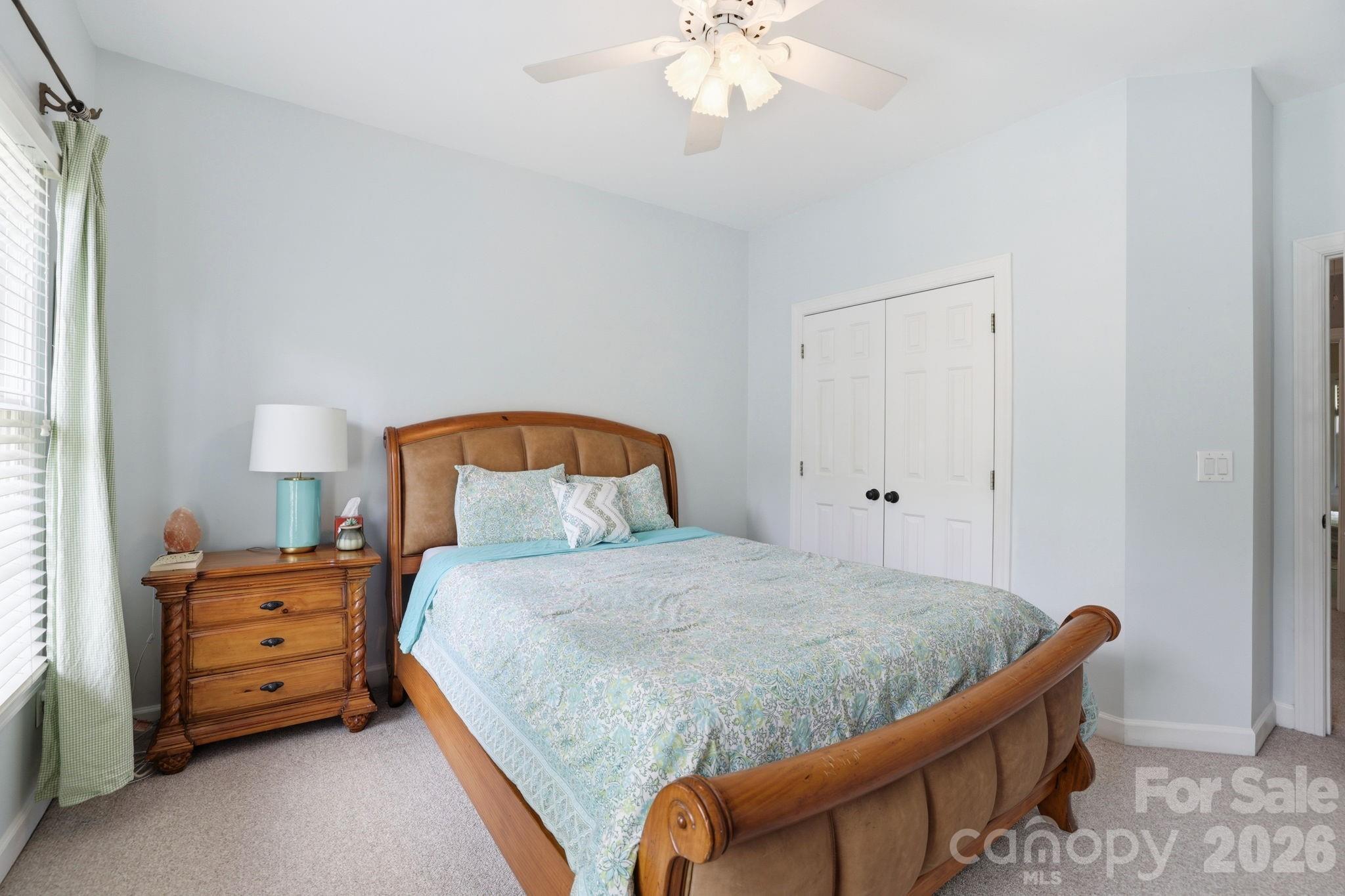 239 Sardis Pointe Road Matthews, NC 28105 - Photo 32 of 47 a bedroom with a bed and a chandelier