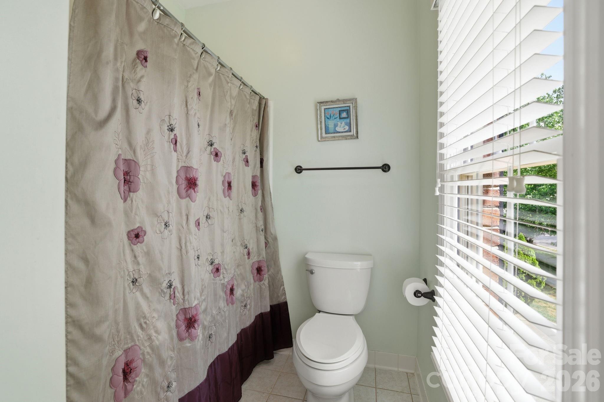 239 Sardis Pointe Road Matthews, NC 28105 - Photo 34 of 47 a white toilet sitting next to a shower curtain