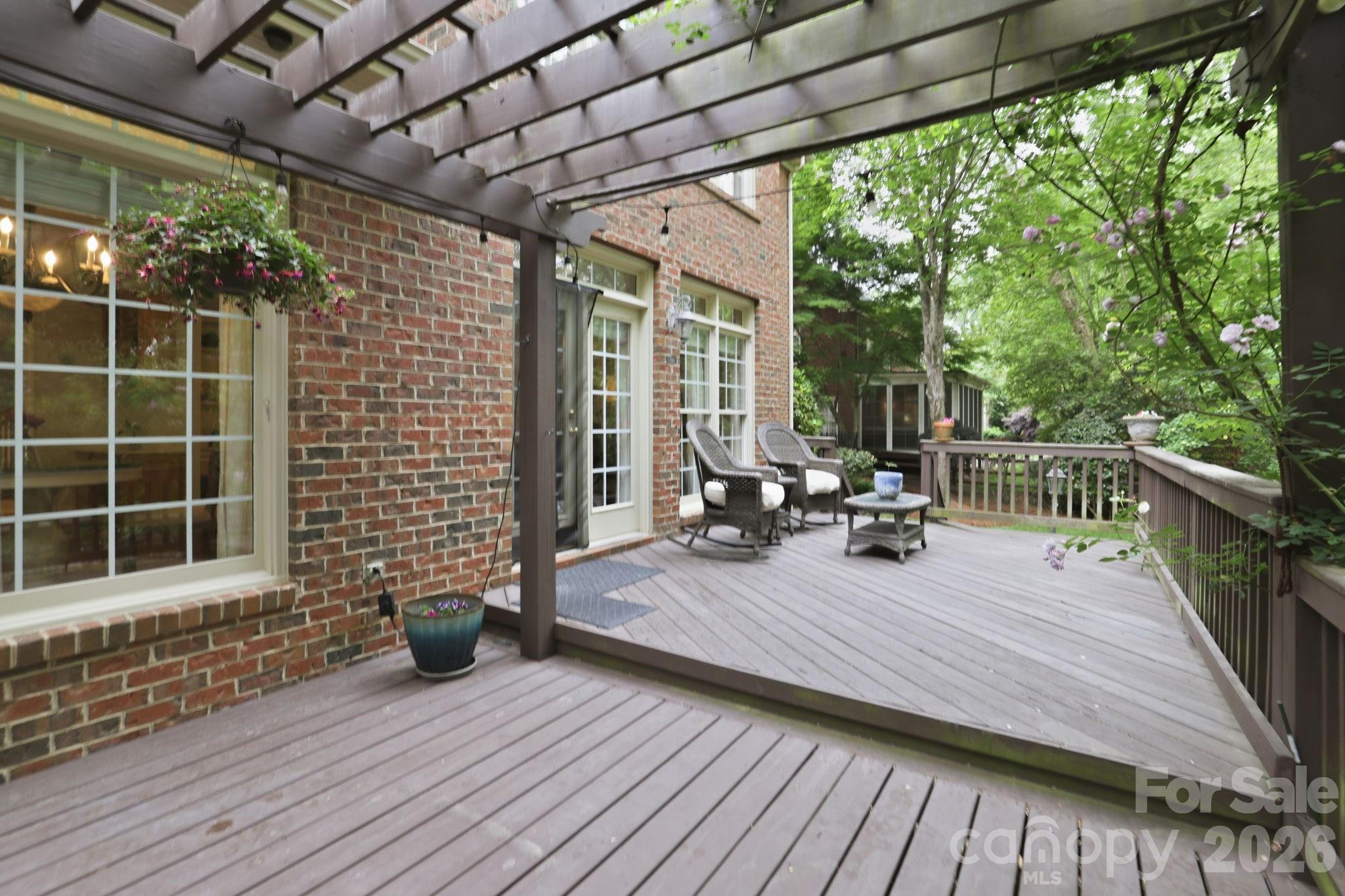 239 Sardis Pointe Road Matthews, NC 28105 - Photo 40 of 47 a view of a deck with wooden floor and roof with a garden view