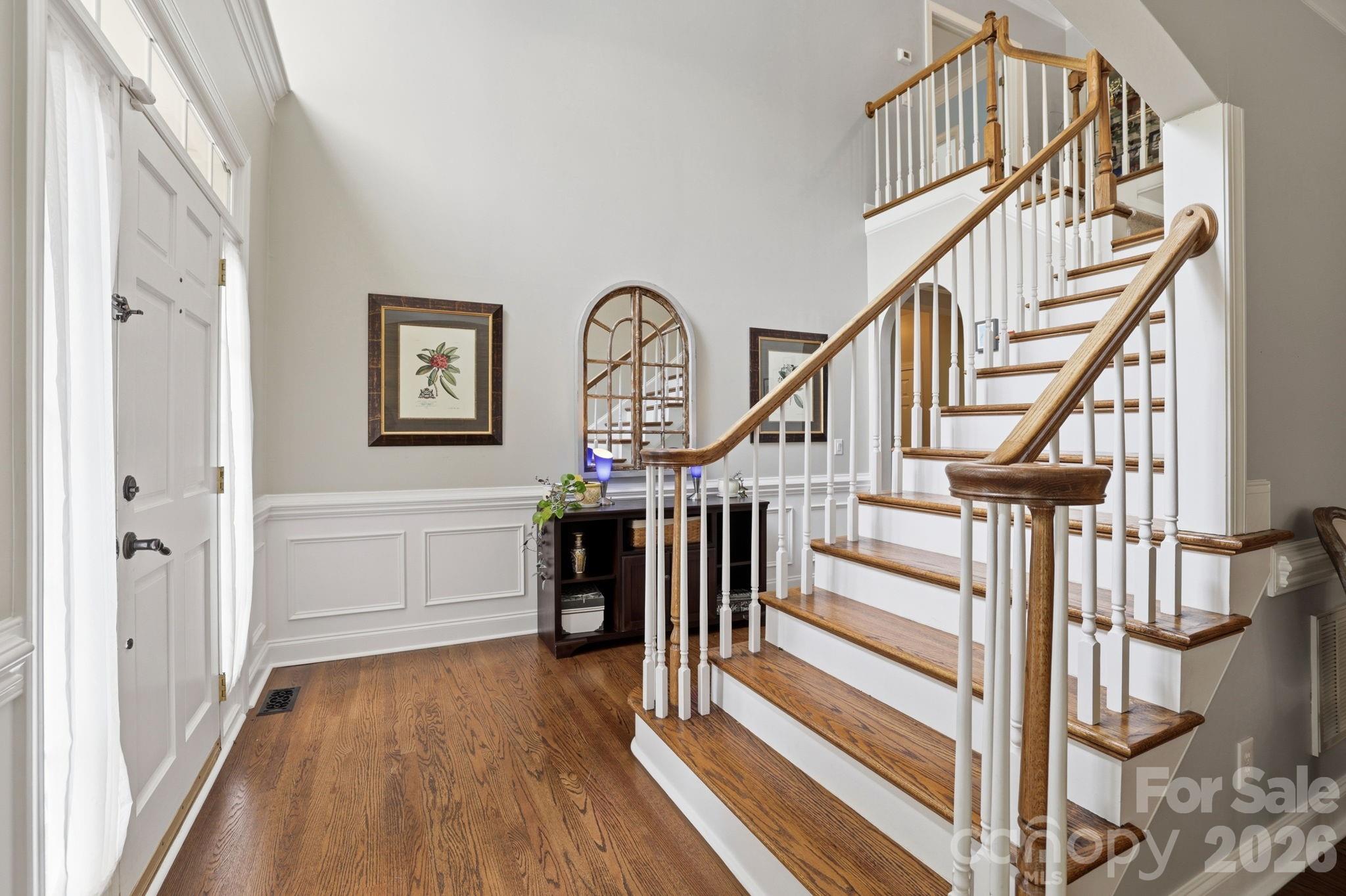 239 Sardis Pointe Road Matthews, NC 28105 - Photo 4 of 47 a view of entryway and hall with wooden floor