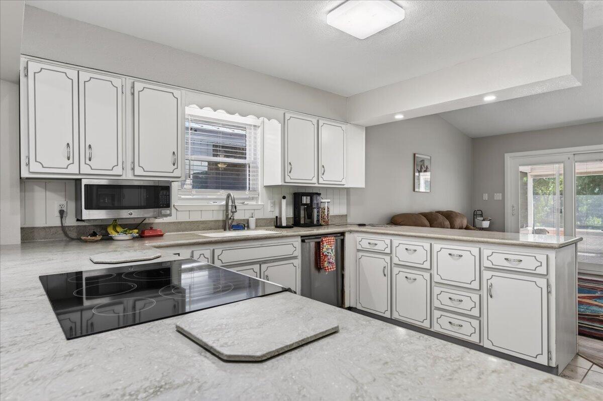 210 Shell Drive Crestview, FL 32536 - Photo 13 of 67 a kitchen with stainless steel appliances granite countertop a stove sink and cabinets