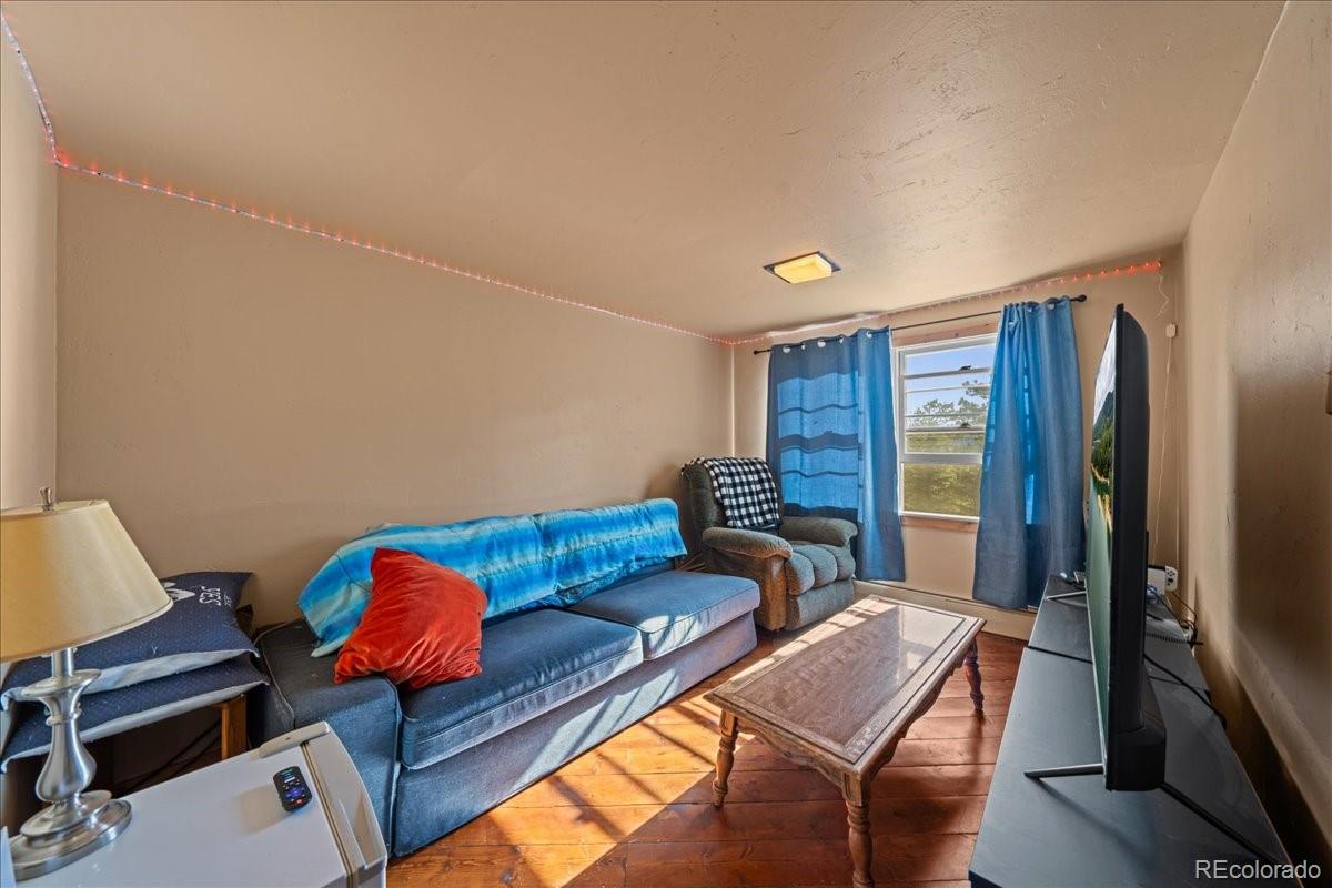40 Ski Road Allenspark, CO 80510 - Photo 13 of 46 a living room with furniture and a flat screen tv