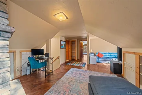 a living room with lots of furniture and kitchen view
