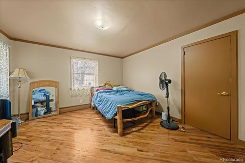 a spacious bedroom with a bed and a window