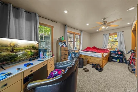 a bed room with furniture and a flat screen tv