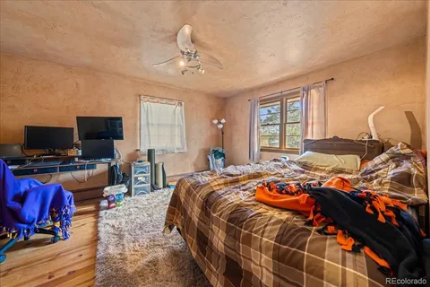 a bedroom with a bed and flat screen tv