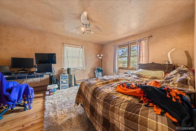 a bedroom with a bed and flat screen tv