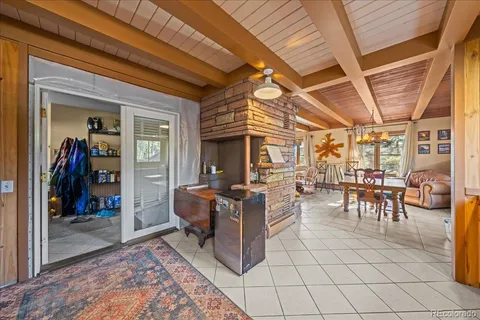 a view of a porch with dining table and chairs