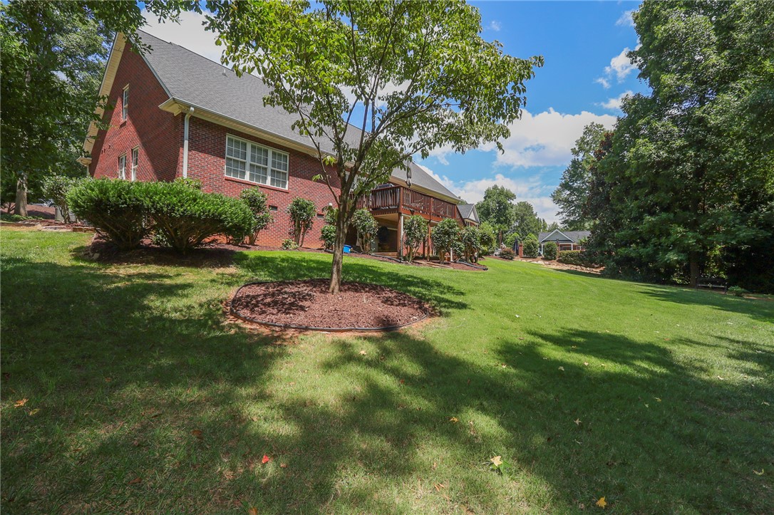 103 C-10-147D Anderson, SC 29621 - Photo 44 of 49 A classic brick exterior graces this residence, complemented by a spacious yard and inviting deck.