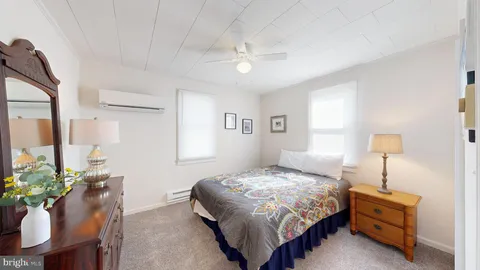 a bedroom with a bed window and a chair