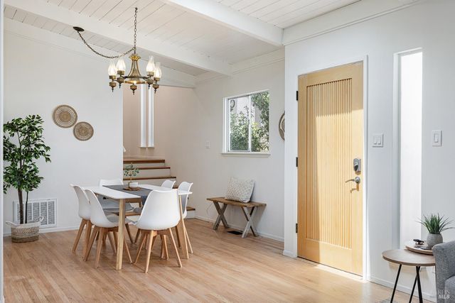 a view of a dining room with furniture and chandelier