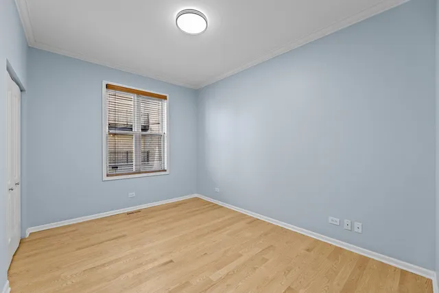 an empty room with a windows and ceiling fan