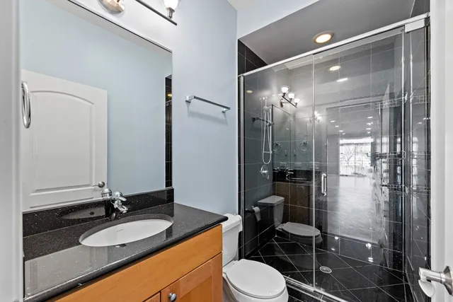 a bathroom with a glass shower door