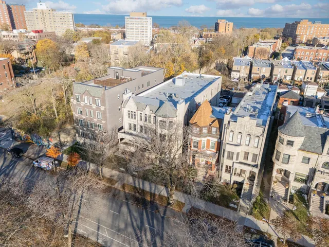 a front view of a residential apartment building with a yard