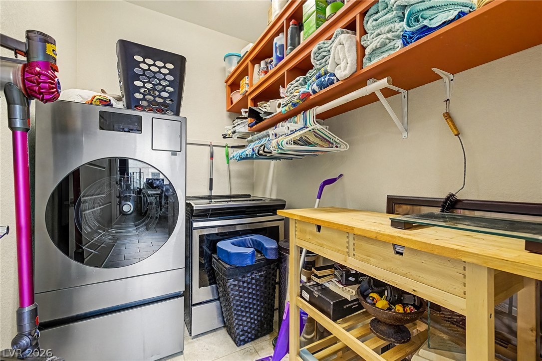 4914 East Beacon Ridge Drive Pahrump, NV 89061 - Photo 25 of 34 Functional utility room with ample storage and built-in shelving for efficient organization.