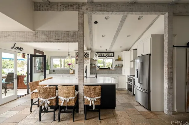 a dining table chair with granite countertop kitchen island stainless steel appliances and furniture