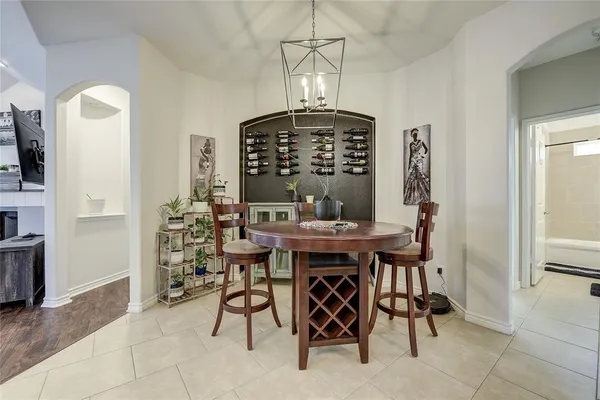 a view of a dining room with furniture and chandelier