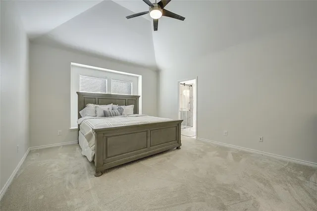 a room with a bed and a ceiling fan