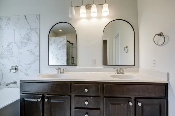 a bathroom with a double vanity sink and a mirror