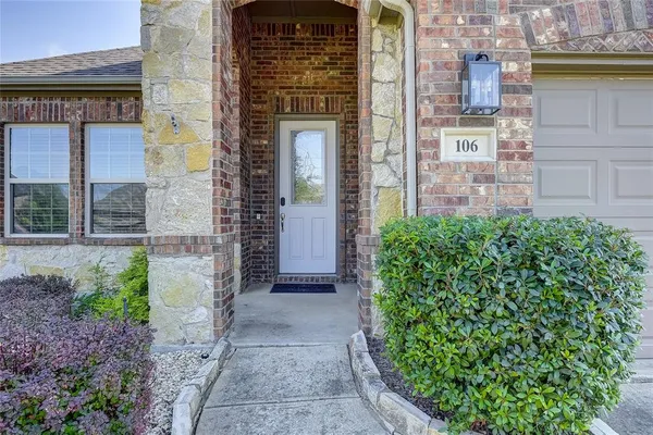 a view of a brick house with a large windows