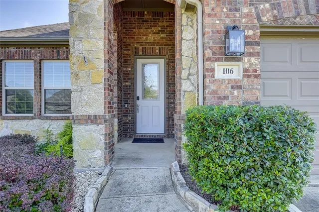 a view of a brick house with a large windows
