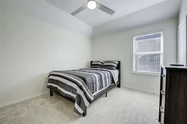 a bedroom with a bed and window