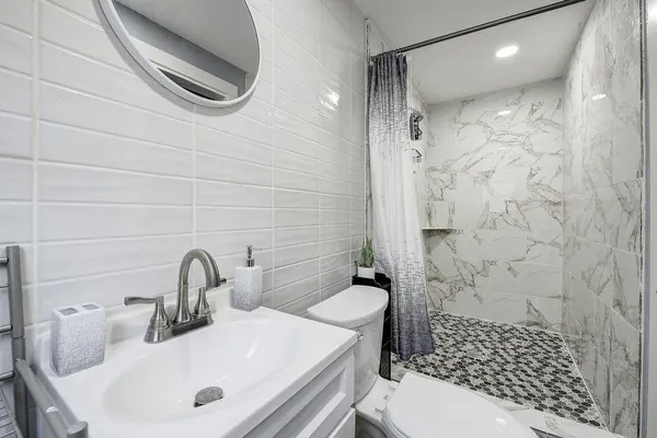 a bathroom with a sink toilet and shower