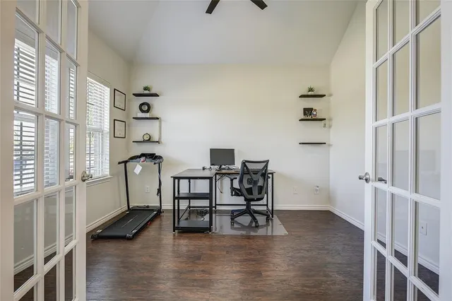 a view of a workspace with furniture and a window