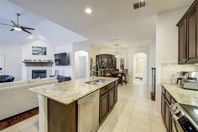 a kitchen with sink stove and refrigerator