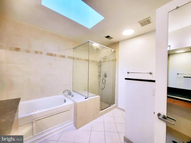 a bathroom with a bathtub shower and a sink