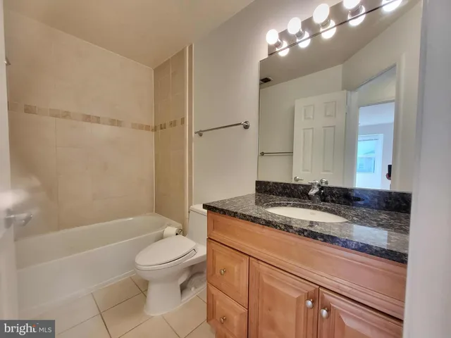 a view of a kitchen with a sink and a refrigerator