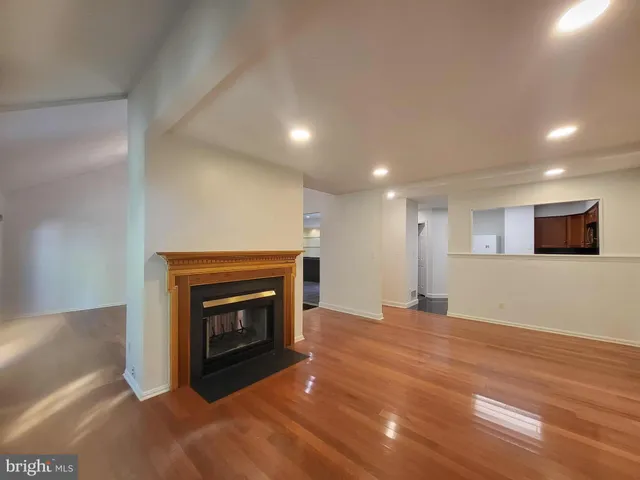 a view of an empty room with a fireplace