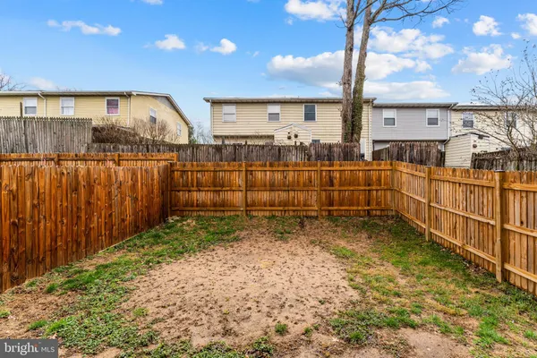 a view of a backyard with wooden fence