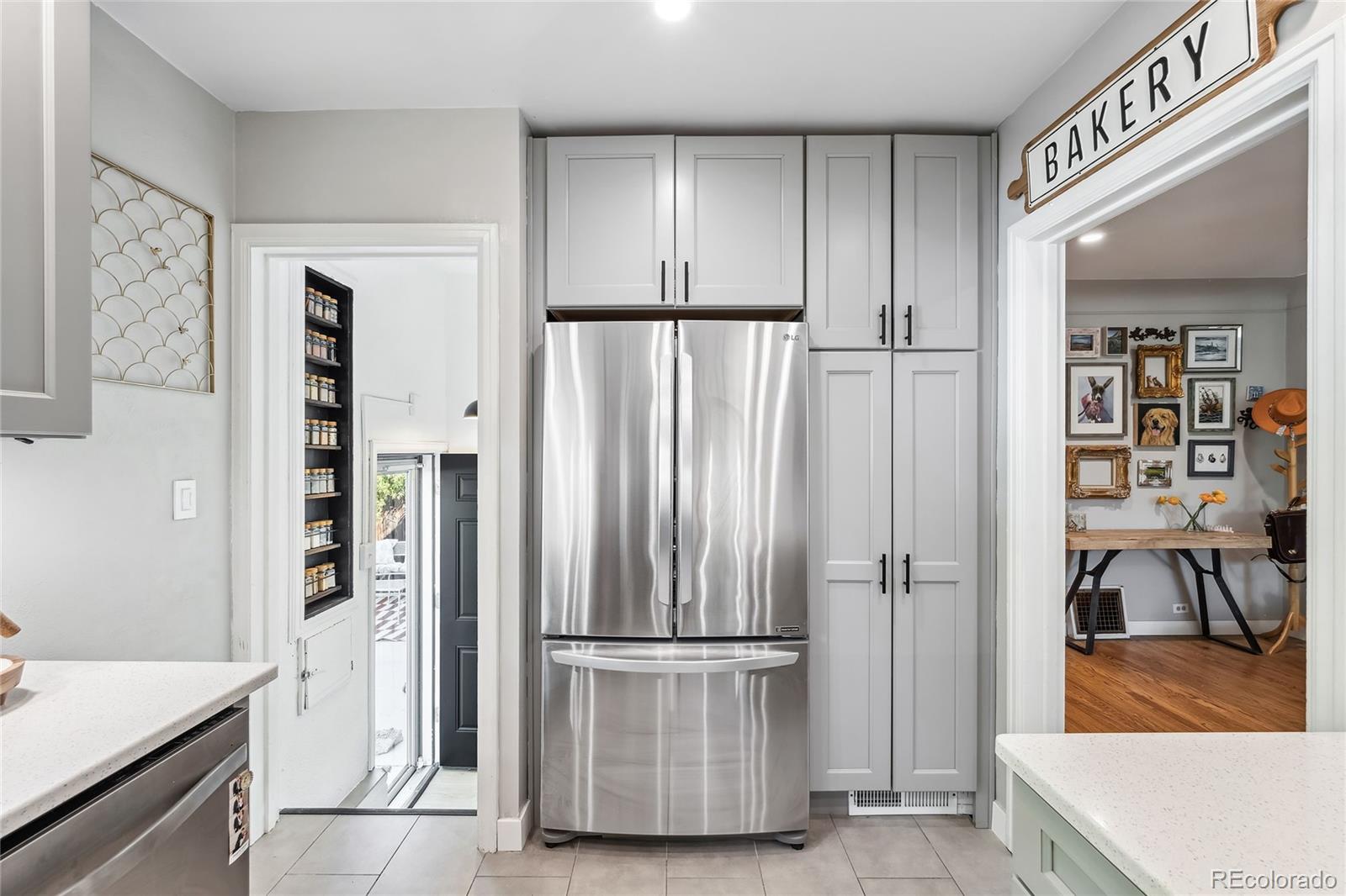 2915 Benton Street Wheat Ridge, CO 80214 - Photo 25 of 42 a kitchen with stainless steel appliances granite countertop a refrigerator and a stove