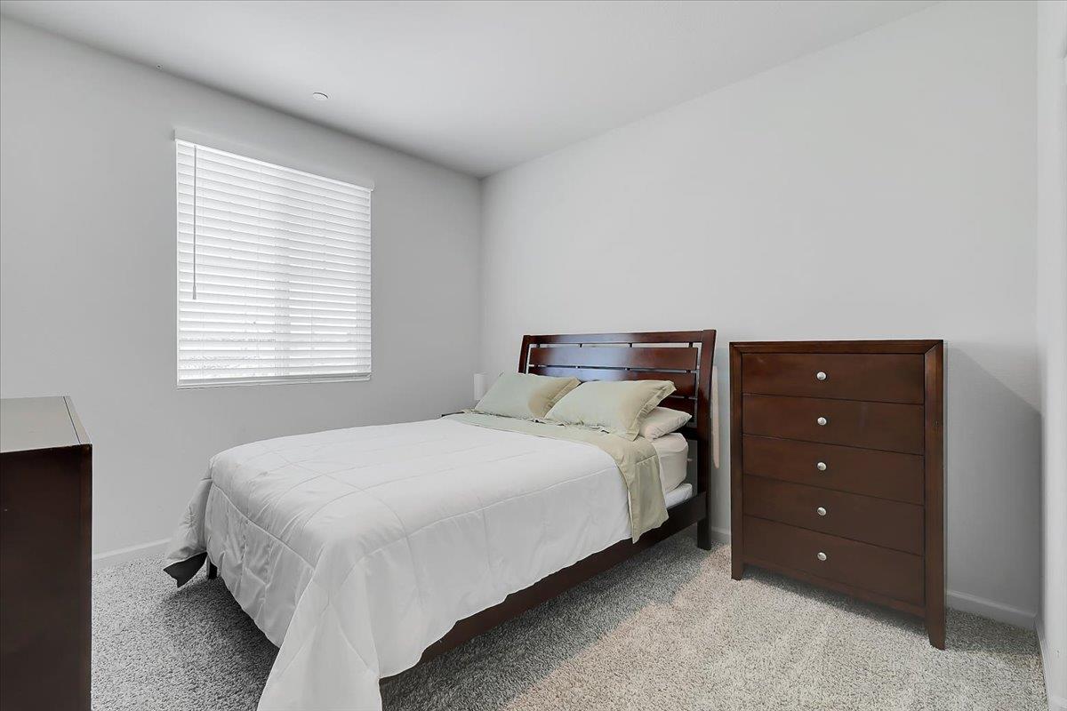 794 Berryessa Way Olivehurst, CA 95961 - Photo 18 of 40 a bedroom with a bed and a window