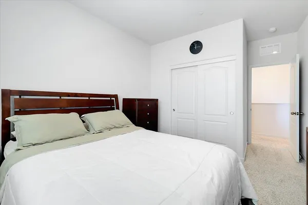 a bedroom with a bed and a window