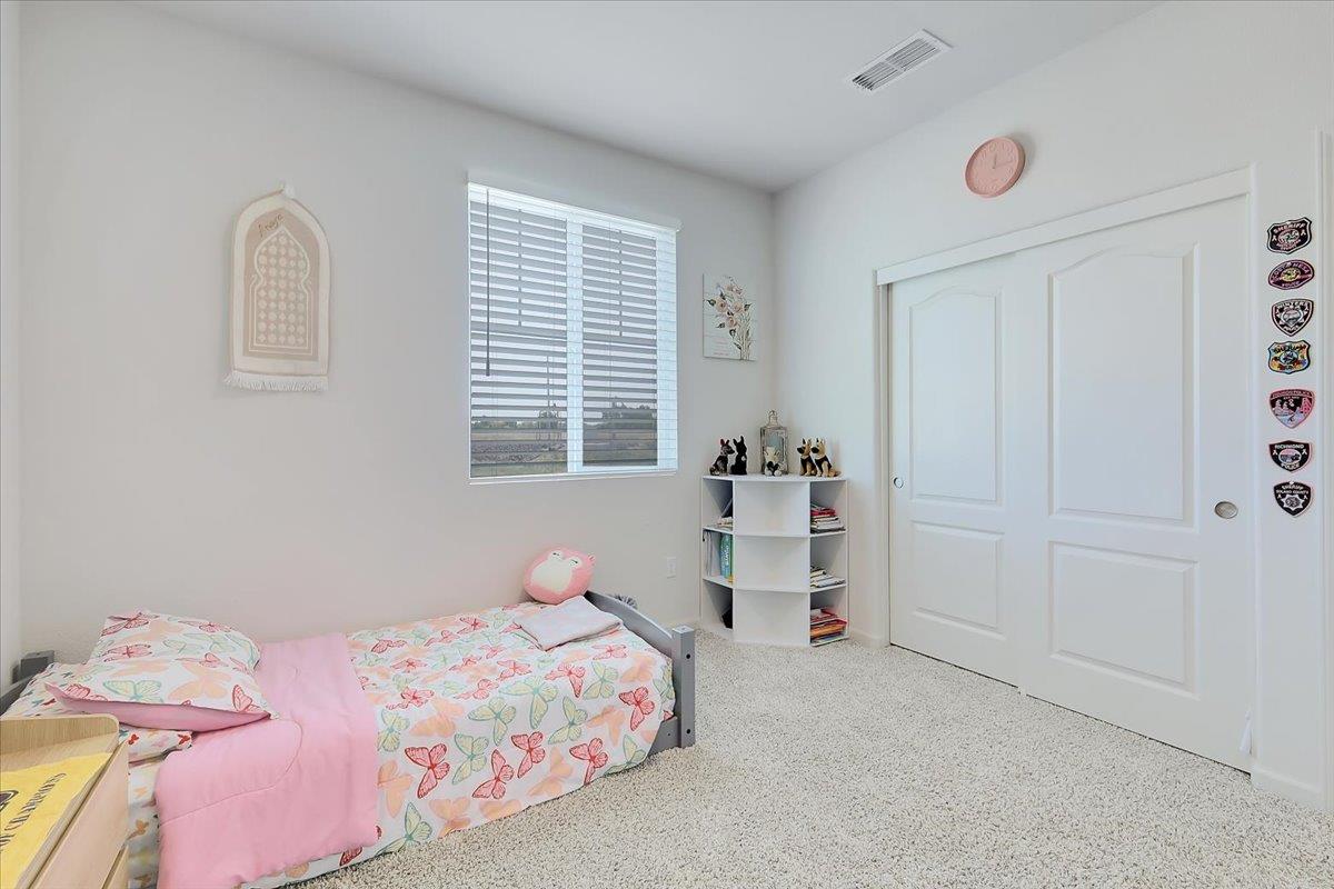 794 Berryessa Way Olivehurst, CA 95961 - Photo 23 of 40 a bedroom with a bed and a window