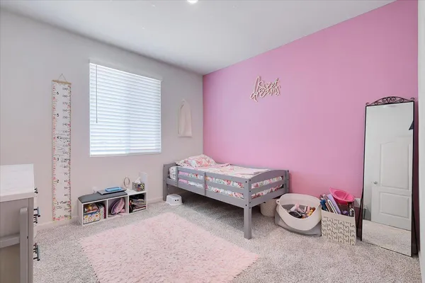 a bedroom with furniture and a window