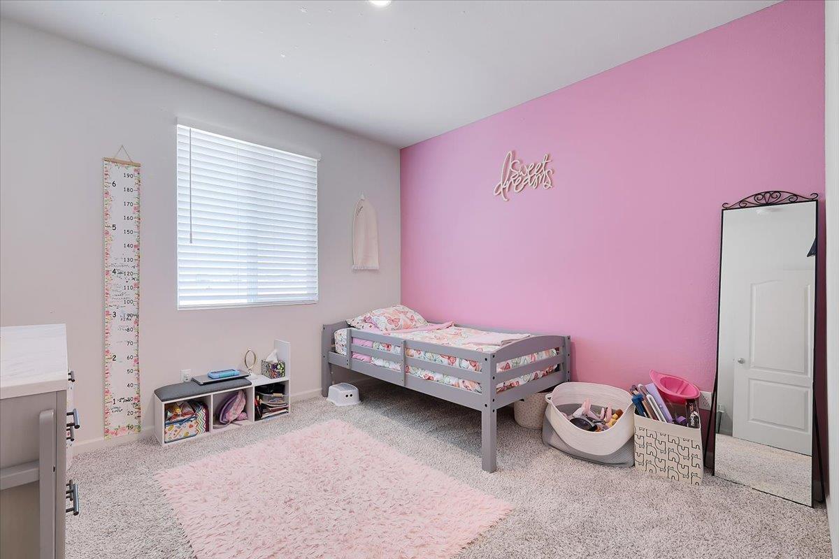 794 Berryessa Way Olivehurst, CA 95961 - Photo 24 of 40 a bedroom with furniture and a window