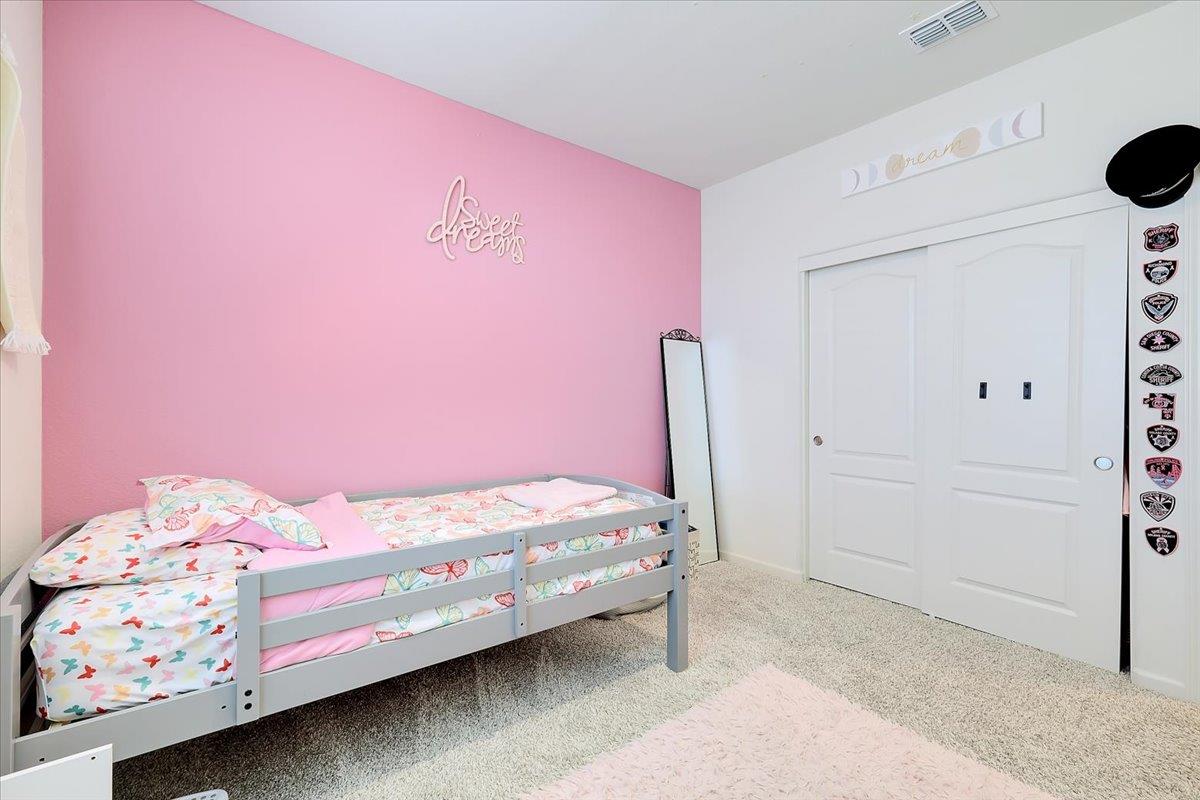 794 Berryessa Way Olivehurst, CA 95961 - Photo 25 of 40 a bedroom with a bed and a window