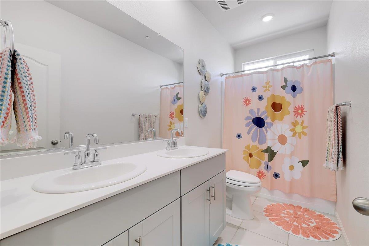 794 Berryessa Way Olivehurst, CA 95961 - Photo 26 of 40 a bathroom with a sink toilet and shower