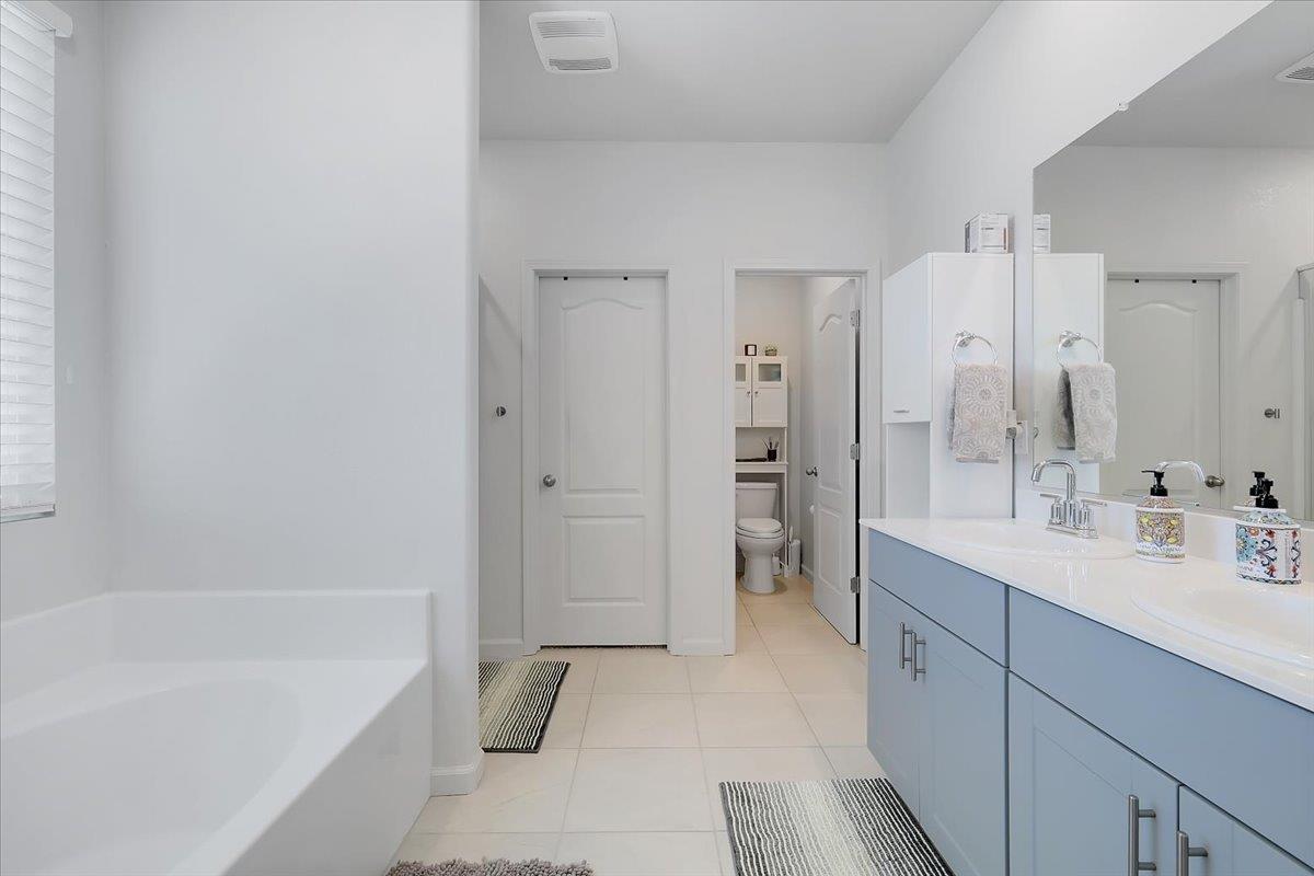 794 Berryessa Way Olivehurst, CA 95961 - Photo 30 of 40 a spacious bathroom with a tub sink shower and mirror