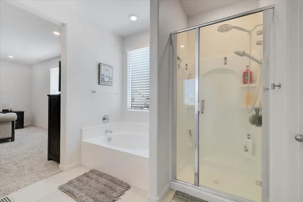 a bathroom with a bathtub and a shower