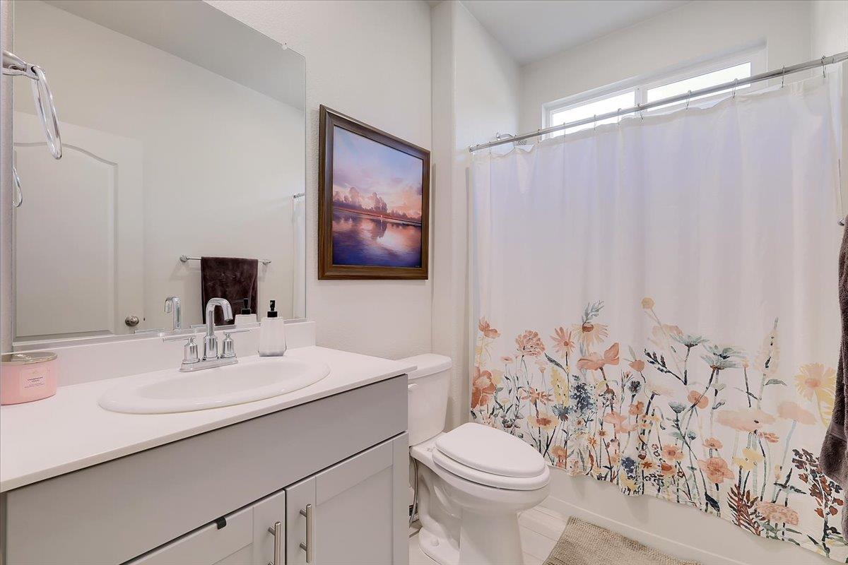 794 Berryessa Way Olivehurst, CA 95961 - Photo 5 of 40 a bathroom with a sink vanity mirror and toilet