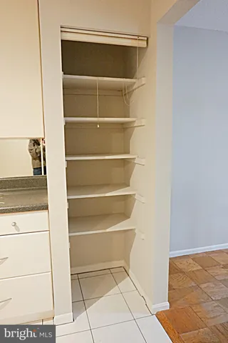 a view of an empty room with window and a ceiling fan