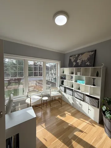 a living room with furniture and a floor to ceiling window